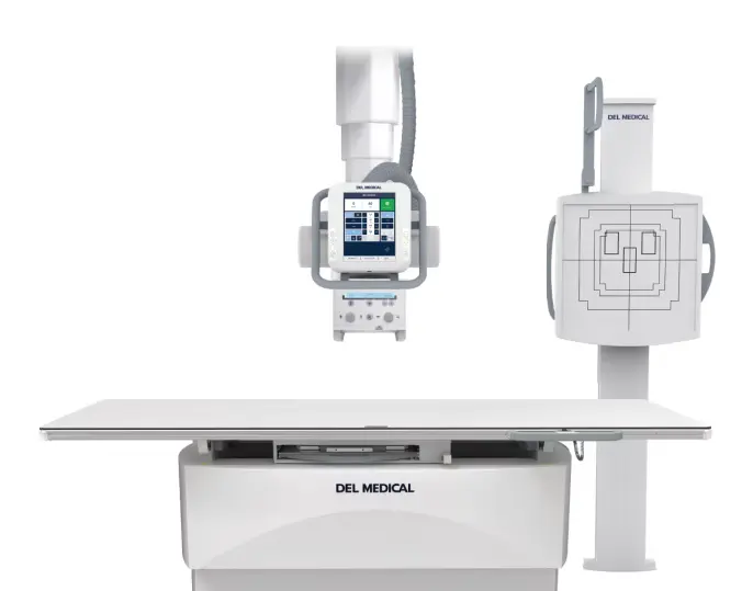A medical X-ray imaging system with a flat table, overhead X-ray tube, and upright detector panel, all labeled DEL MEDICAL.